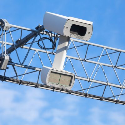 Dopravní kamera Traffic enforcement camera closeup photo over blue sky